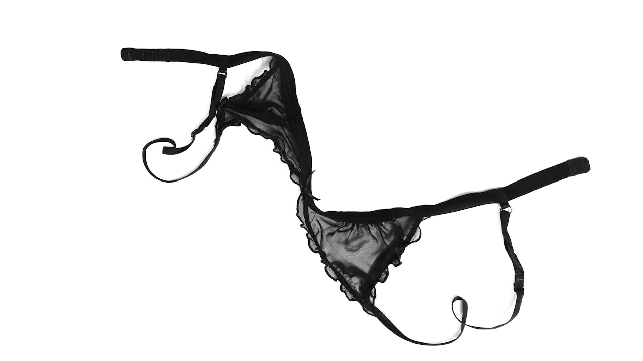 Home Elegant black lingerie on a plain white background, highlighting its delicate design.